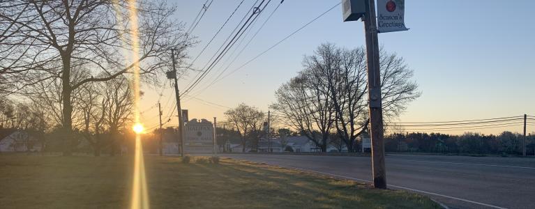 town-hall-sign-facing-route-106-east-at-sunrise